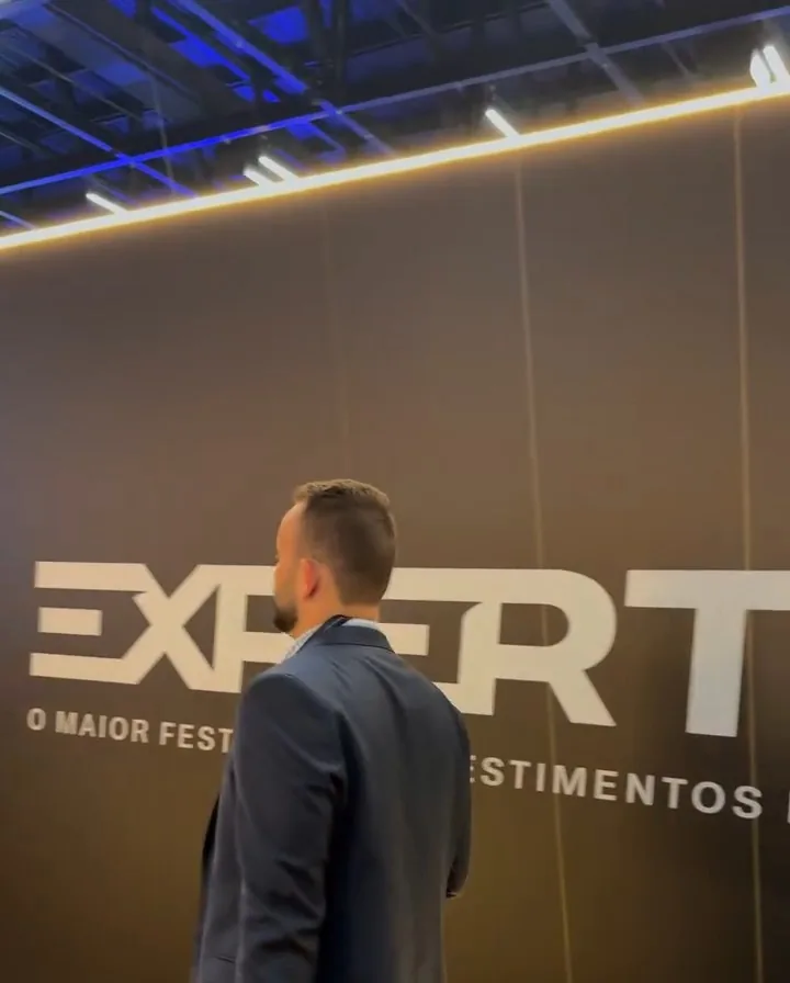 Integrante da Maxcon diante do painel da Expert, o maior festival de investimentos